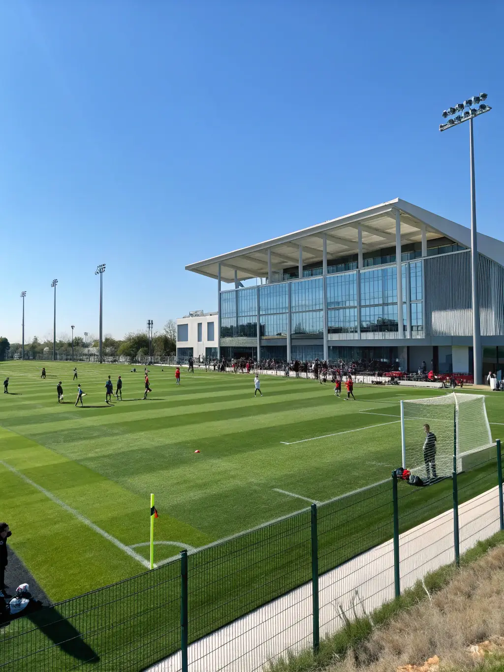 A panoramic view of a MILAN STAGE FOOT training camp, showcasing the state-of-the-art facilities and the beautiful Auvergne Rhone Alpes landscape.
