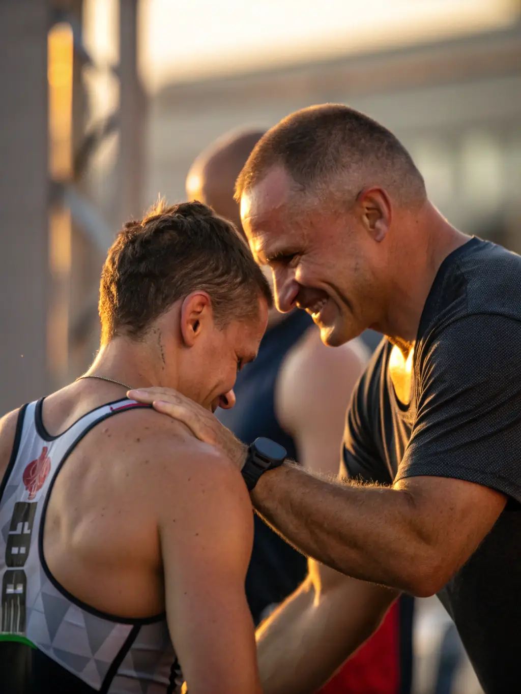 A young player with a big smile, receiving encouragement from a coach after a successful play, symbolizing increased confidence.
